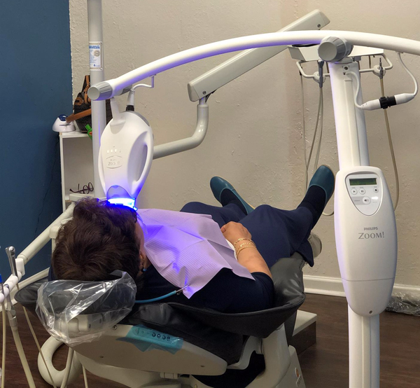 Patient completing teeth whitening in office
